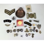 Assorted military badges, buttons, coin, plaques, ashtray and patches