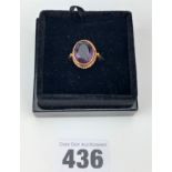22k gold band witha large purple amethyst stone in a 9k setting