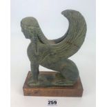 Resin model of sphinx on stand. 9.5” high