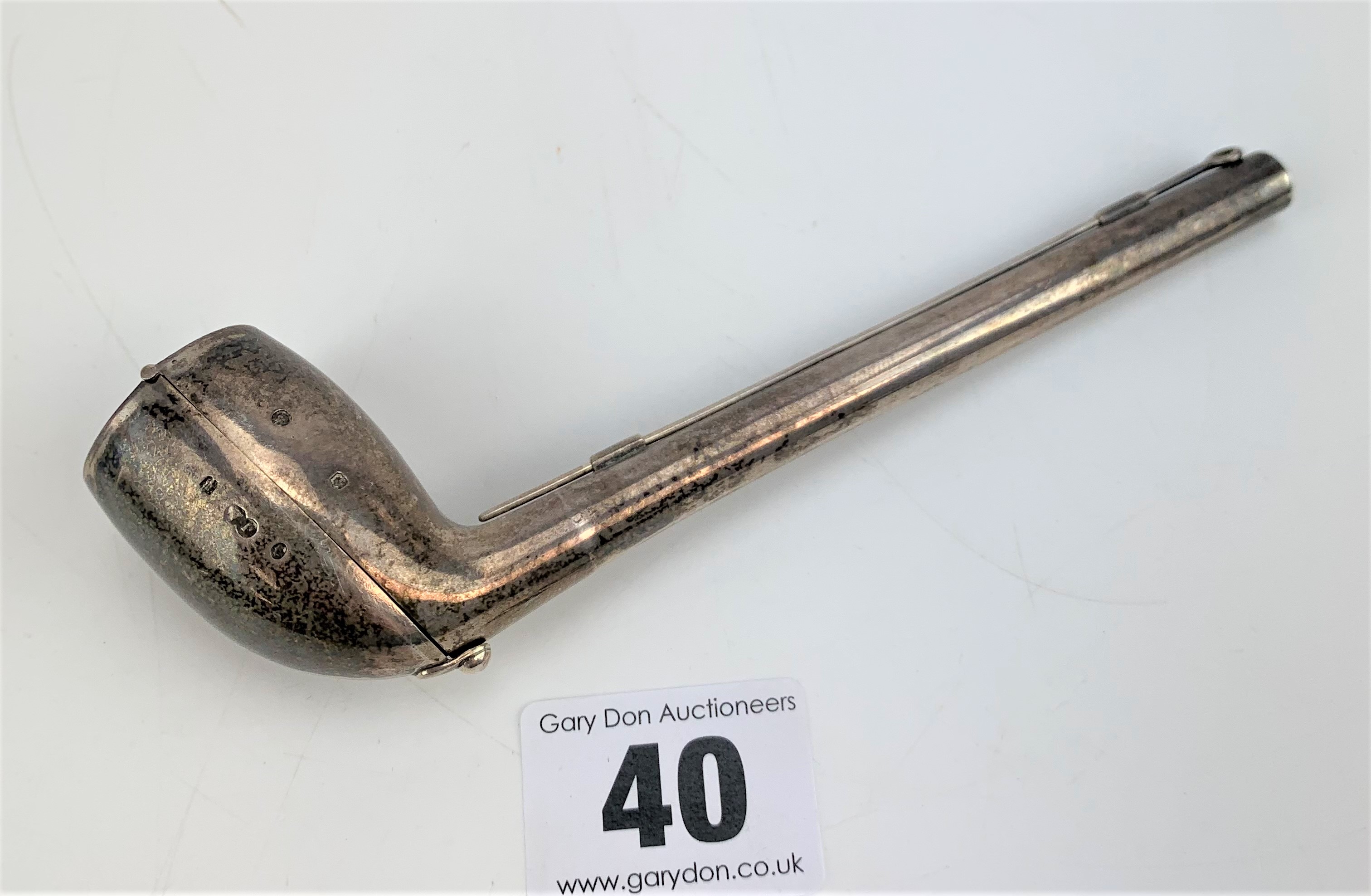 Silver pipe box containing clay pipe