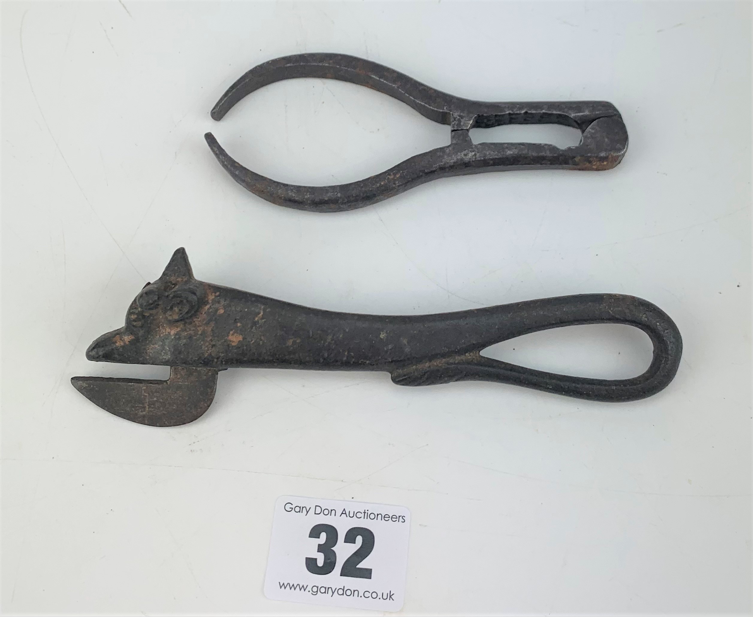 1885 bulls head can opener and metal tongs