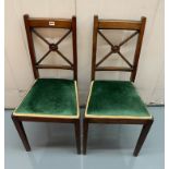 2 carved green seated chairs