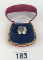 White metal ring (stamped 18k) with green stone