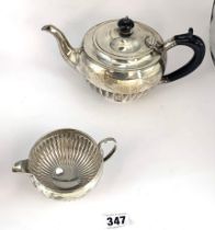 Silver teapot and cream jug