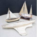 Wooden pond yacht hull 'Swift', 36" long; together with a model fishing boat and another model yacht