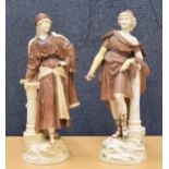 Pair of Rudolstadt, Germany blush porcelain figures, each modelled standing by Corinthian columns,