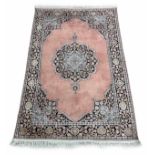 Indian silk rug, with a central medallion on a pink ground, 73" x 42"