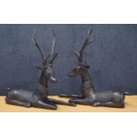 Pair of bronze recumbent deer figures, each decorated with Indian geometric embellishments, each 20"