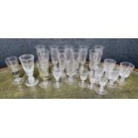 A good selection of antique and later glass to include nine tall ale lens facet cut glasses, wine