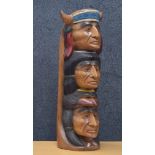 Carved wooden native American totem pole, of three warrior figure heads, polychrome decorated, 20"