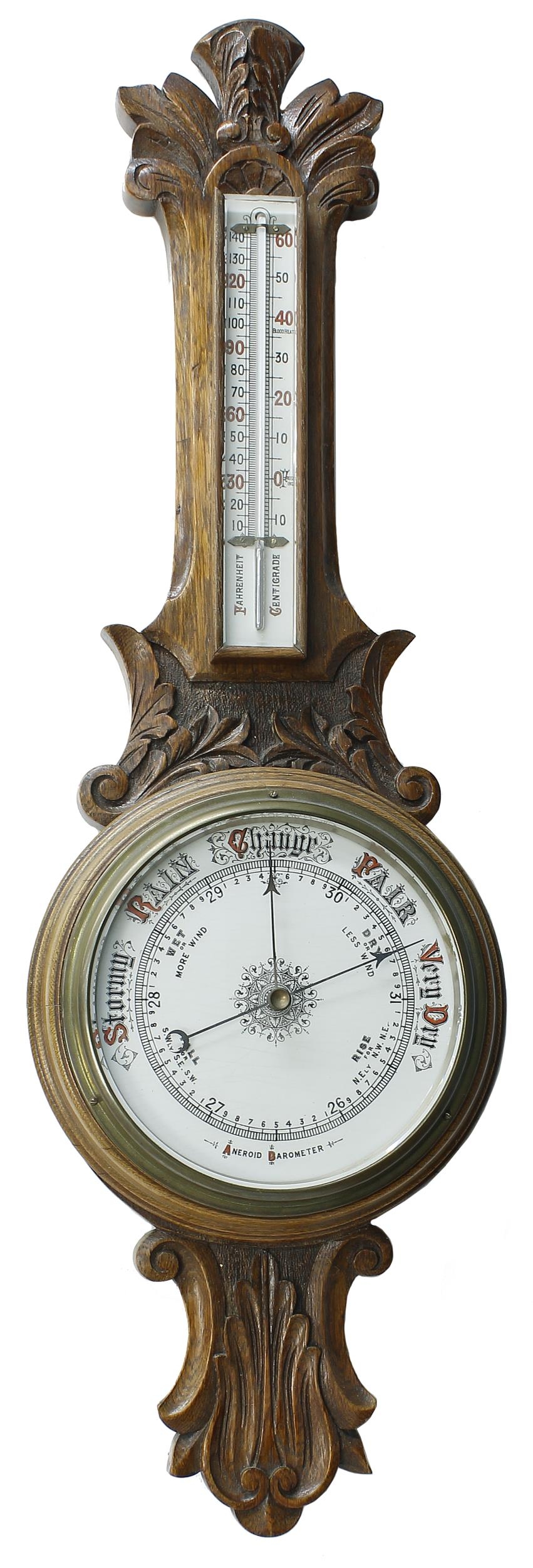 Oak aneroid barometer/thermometer, the 8" principal cream dial within a foliate carved case, 33"