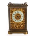 Attractive carriage clock timepiece, the 2" cream chapter ring within a blind fret foliate pierced