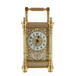 Attractive carriage clock timepiece, the 1.75" cream chapter ring within a gilt foliate filigree