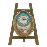 Attractive French porcelain and brass miniature easel clock timepiece, the oval porcelain dial plate