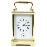 French carriage clock timepiece with alarm, within a corniche brass case, 7" high