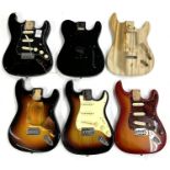 Five Strat type and one Tele type guitar body for projects, some loaded with hardware and