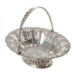 Small Victorian silver bonbon basket, with cast pierced twist swing handle over a pierced body,