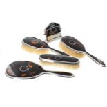 George V four piece silver and tortoiseshell piqué table brush and hand mirror set, decorated with