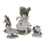 Selection of porcelain figures; a figural spill vase with a winged putto grasping a swan,