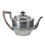 Victorian silver oval teapot, the hinged cover with hardwood finial and the half reeded body with