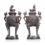 Pair of Japanese bronze Koros with covers, each with Fo dog finials and dragon cast handles, the