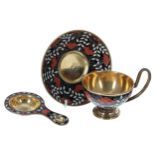 Russian silver gilt and cloisonné cup, saucer and tea strainer, decorated with leaves and berries on