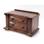 Good figured walnut desk top miniature chest of two drawers, with architectural reeded pillars