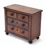 Mahogany apprentice miniature chest of two short over two long graduated drawers, raised on turned