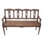 18th century French oak chair back bench, the backs with carved scroll and foliate wreath over