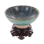 Islamic small pottery glazed circular footed bowl, possibly 12th/13th century, with green iridescent