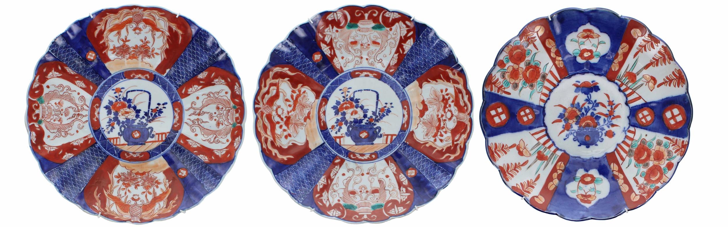 Three similar Japanese Imari fluted porcelain wall chargers, each with foliate designs in typical