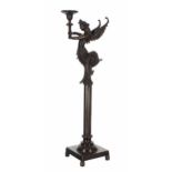 Decorative bronze figural candle holder, cast as a winged caryatid with scrolling tail, upon an