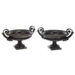 Pair of 19th century Continental decorative bronze urns, with twin scroll and mask handles over a