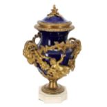 Impressive French gilt metal and marble mounted blue glaze ceramic urn with cover in Louis XVI
