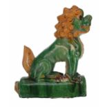 Chinese sancai glaze roof tile modelled as a seated Buddhist lion, 11" high