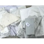 Collection of assorted white cotton table cloths, place mats and napkins, some with subtle