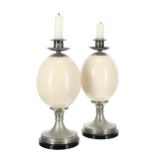 Pair of Anthony Redmile ostrich egg candlesticks, with silver plated mounts and drip pans raised
