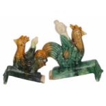 Chinese sancai glaze roof tile modelled as a man riding a rooster, 11.5" high; together with a