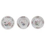Two Chinese famille rose porcelain plates and a shallow bowl, each decorated with flowers, Qianlong,