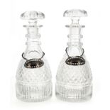 Pair of Regency cut glass decanters with stoppers, 10.5" high; with two George Nangle silver