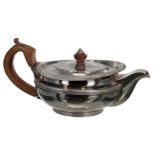 George III silver teapot, of low squat form with cast reeded rim, hardwood finial and handle,