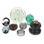 Seven decorative glass paperweights, to include a green Nailsea example, two millefiori examples,