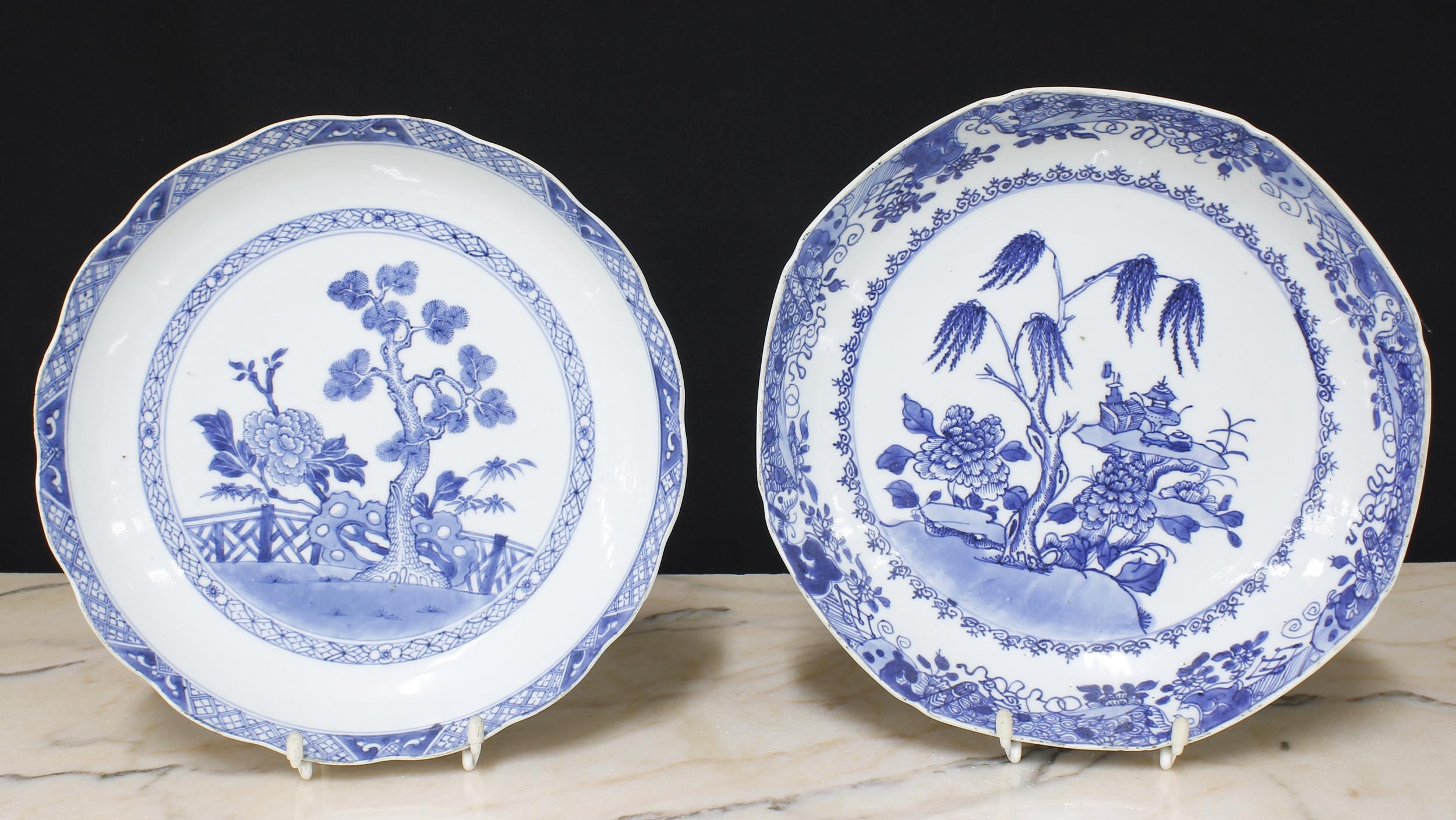 Pair of Chinese export blue and white porcelain circular plates, decorated with boats in a landscape
