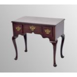 George III mahogany lowboy, the rectangular moulded top over three freeze drawers and a shaped