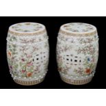 Pair of Chinese porcelain barrel window seats, with pierced motifs and decorated with trees in