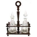 Regency rosewood twin bottle stand, with central turned and ring handle, raised on four finely