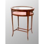 Attractive oval inlaid bijouterie display table cabinet, the hinged top with an inset bevelled glass