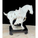 Chinese unglazed pottery horse, Tang dynasty, upon a later stand, 9.5" high (faults)