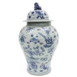 Large Chinese blue and white porcelain baluster temple jar and cover, decorated with scrolls,