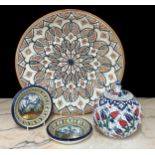 Large Moroccan stoneware pottery charger, decorated with geometric stylised petals, on a natural